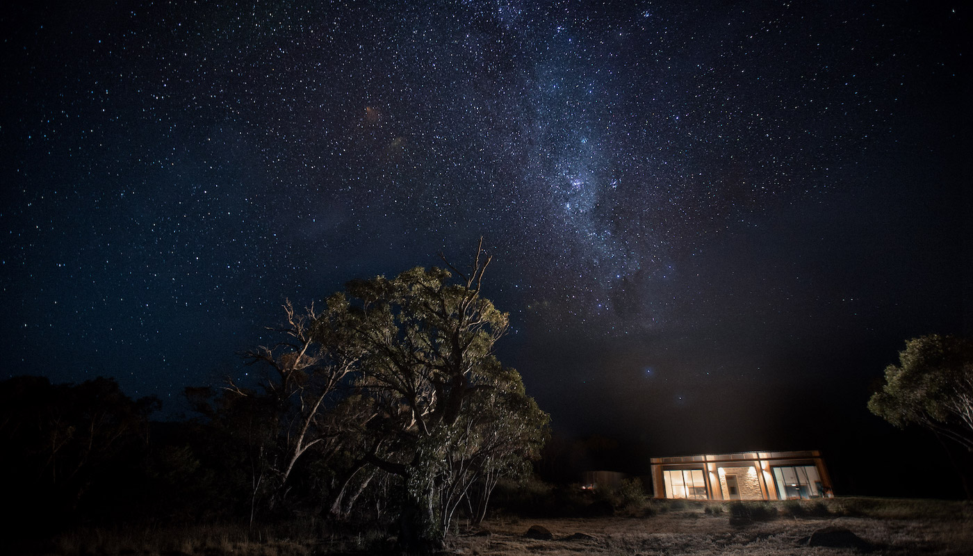 A romantic cabin in the Snowy Mountains under a starry sky